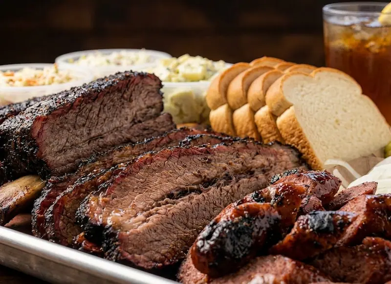 Exterior of Iron and Oak Brisket Co. in Woodfin, NC, a boutique BBQ spot famous for USDA Prime Brisket and riverside vibes.